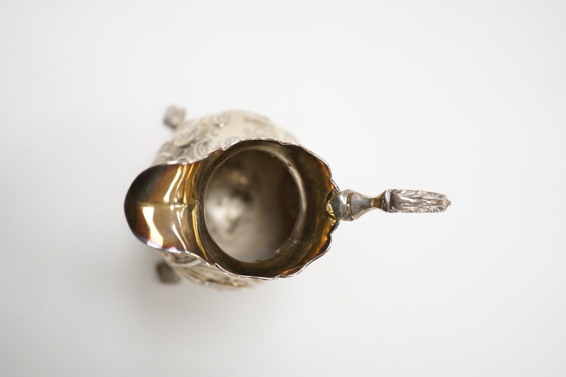 A George II small silver cream jug by David Mowden, London, 1754, of baluster form, with later embossed decoration, height 99mm, 79 grams.